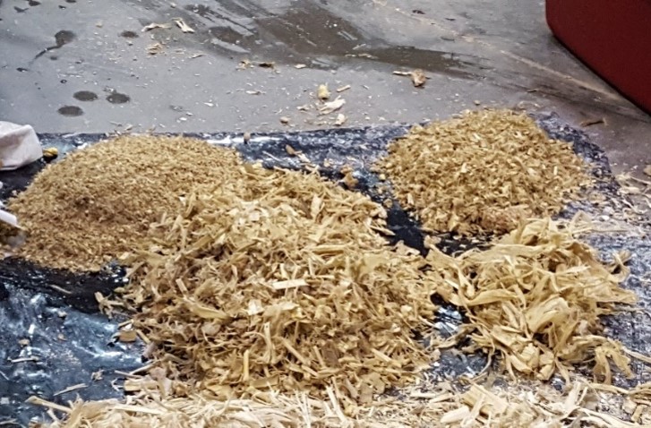 Corn silage that has been through the particle size separator boxes. There are four fractions ranging from coarse to fine, all arranged on a sheet of plastic.