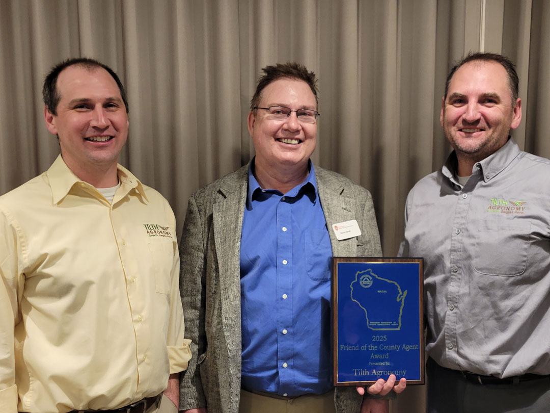 Tilth Agronomy representatives Todd Schaumberg (left) and Bill Schaumberg (right) receiving the Friend of the County Agent Award presented by Kevin Jarek Regional Crops and Soils Educator (center).
