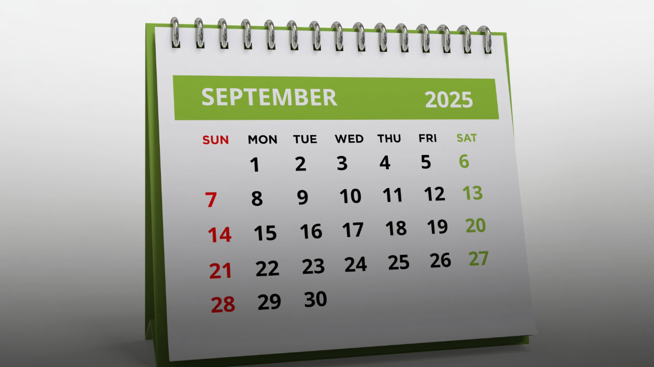 September 2025 desk calendar with green header showing monthly grid, Sundays in red, Saturdays in green